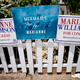 Marianne Williamson for congress signs, including one that says "Mermaids for Marianne"